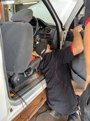 Mechanic Working Inside Car With Open Door And Hood — KND Autos in Berrimah, NT