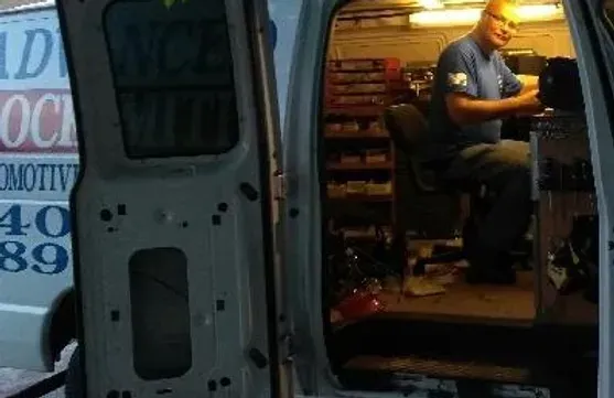 A man is working in the back of a van that says 40 89