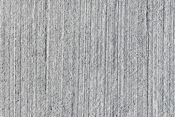 Textured gray concrete surface with vertical striations.