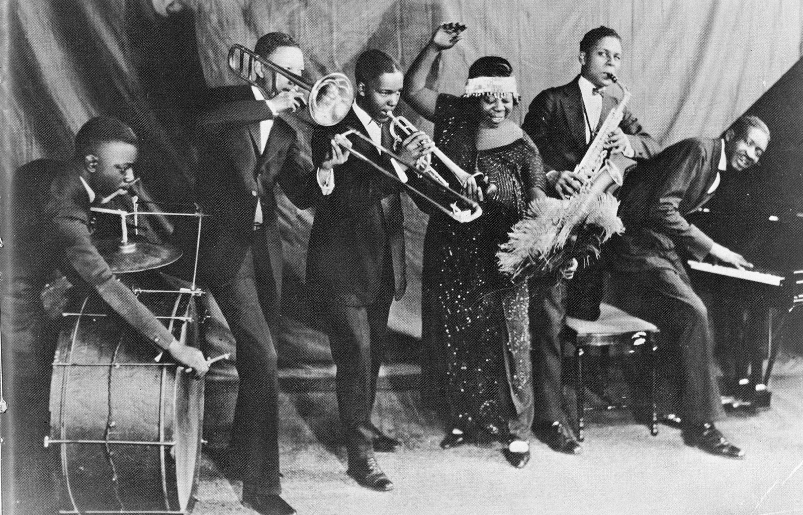 A black and white photo of a band playing instruments