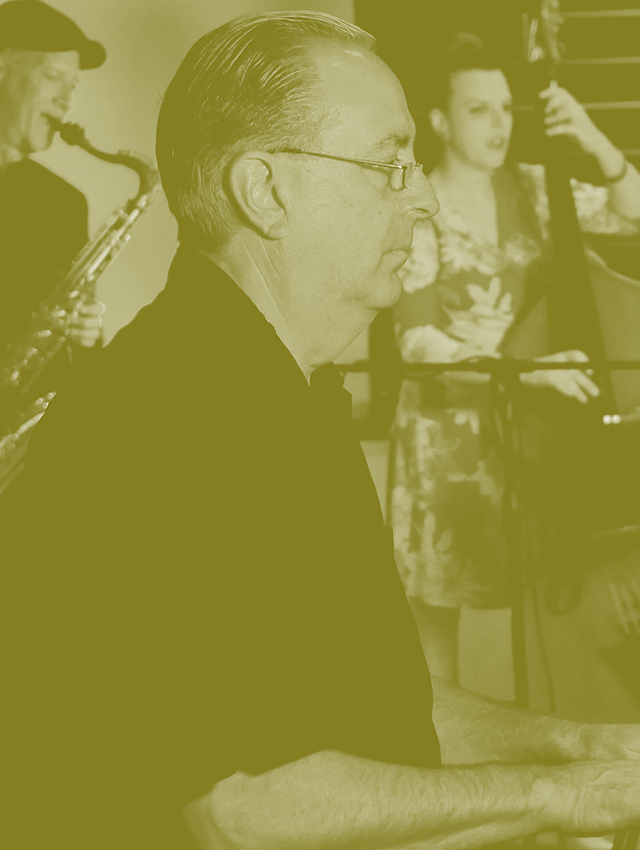 A man is playing a piano in a black and white photo.