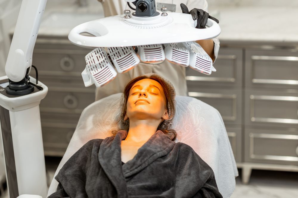Woman Receiving Red Light Therapy on Her Face at a Spa — Bombshell Body Bar In Meikleville Hill, QLD