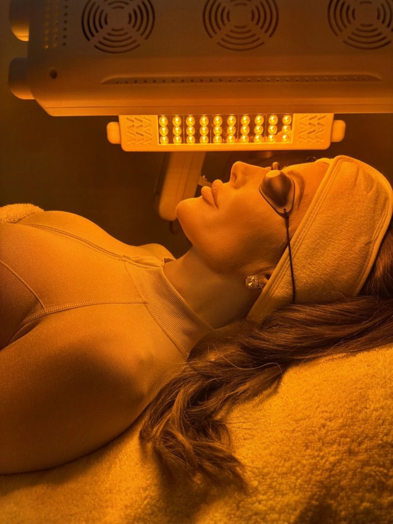 Woman Receiving Green Light Therapy for Her Face — Bombshell Body Bar In Meikleville Hill, QLD