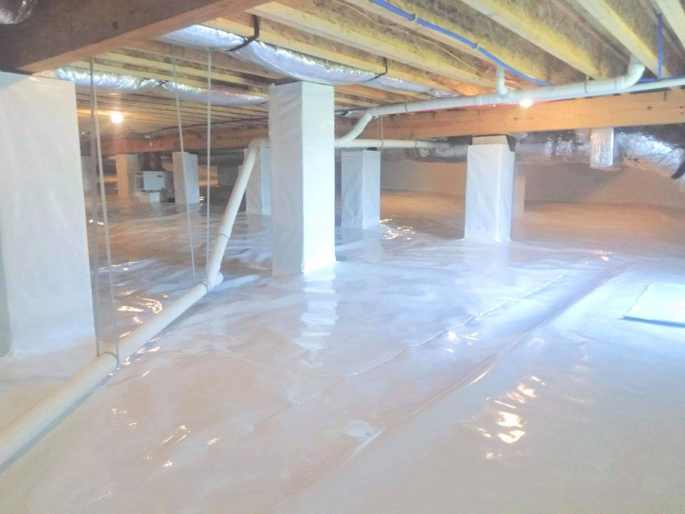 A basement with a lot of plastic on the floor.