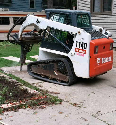 concrete removal job with skidsteer
