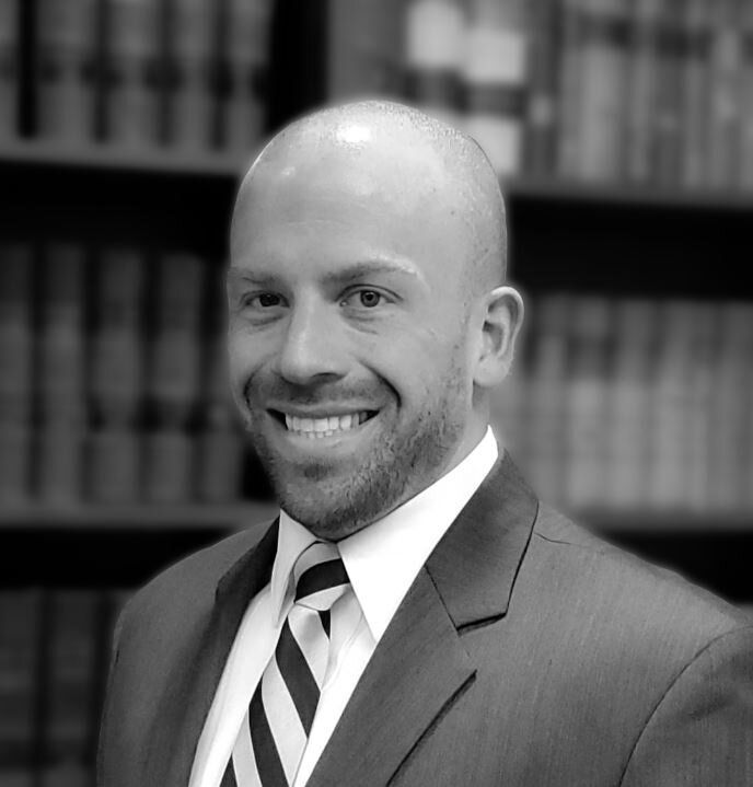 a man in a suit and tie is smiling in a black and white photo