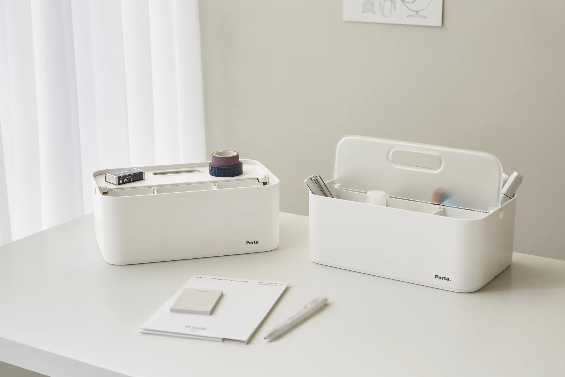 Dos cajas blancas están sobre una mesa blanca.