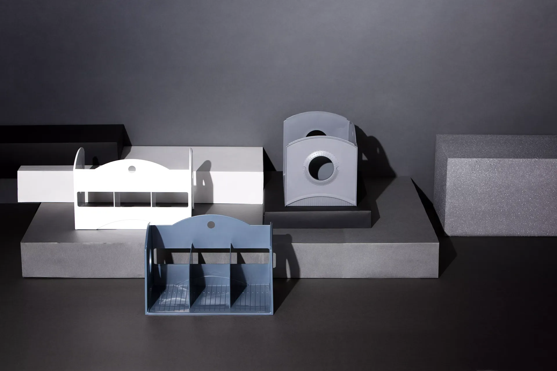 Tres maquetas de una casa están sobre una mesa.