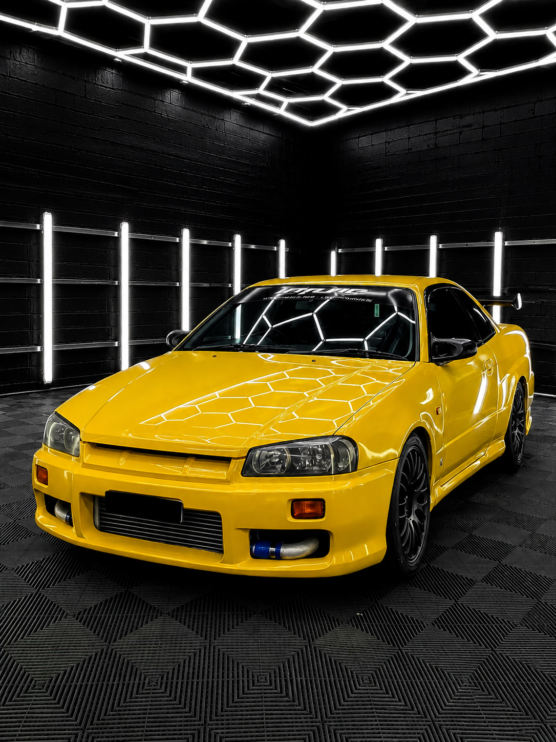 Yellow sports car in a dark showroom with hexagonal ceiling lights