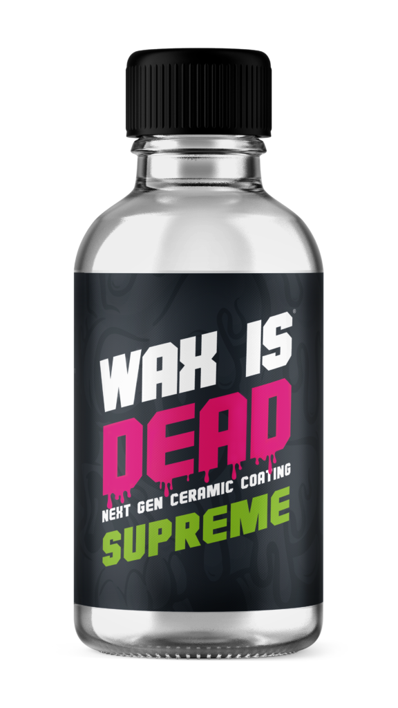 Bottle with black label reading “WAX IS DEAD” in white, pink, and green text on a silver background.