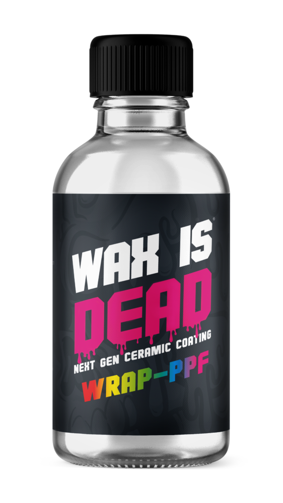 Small clear bottle with black cap and label reading “WAX IS DEAD” in white, pink, and yellow text.