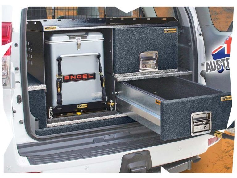 The back of a white truck with a cooler and drawers