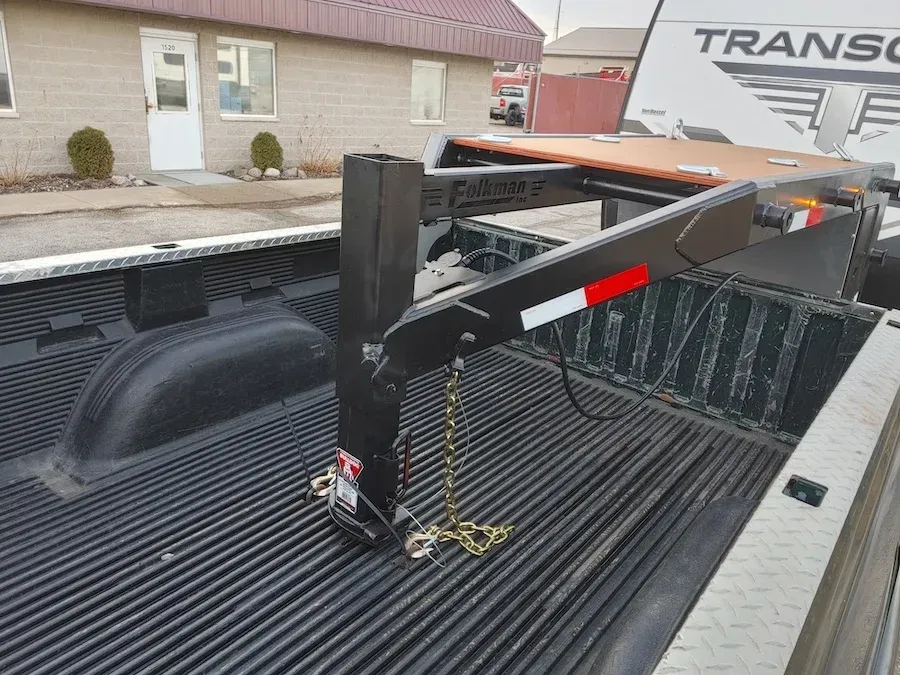 The back of a truck with a trailer attached to it.