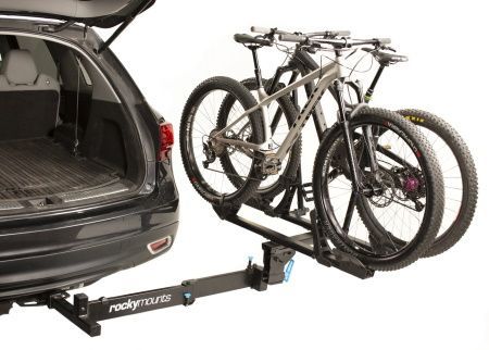 A bicycle rack is attached to the back of a car.