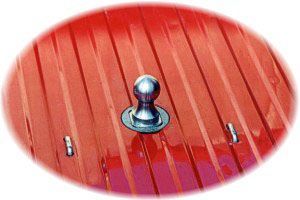 A red roof with a metal ball attached to it.