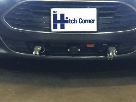 A black car with a license plate that says the hitch corner