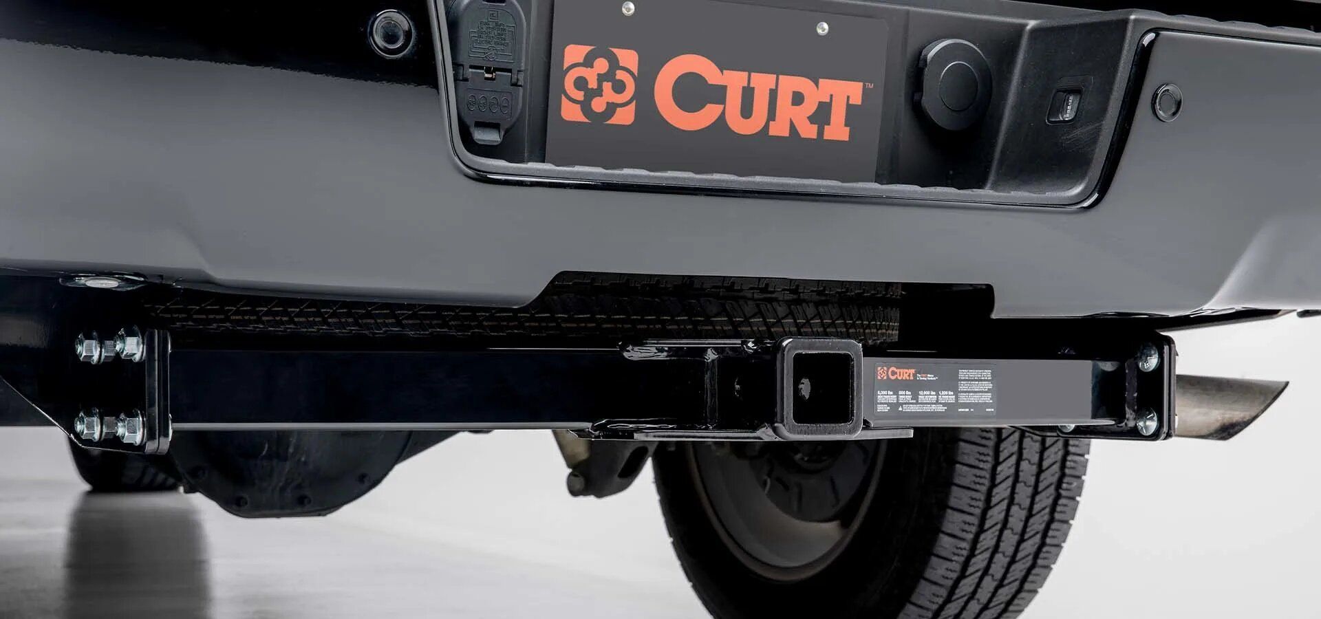 A black truck with a curt trailer hitch attached to it Littleton Colorado How to Maintain Trailer Hitch