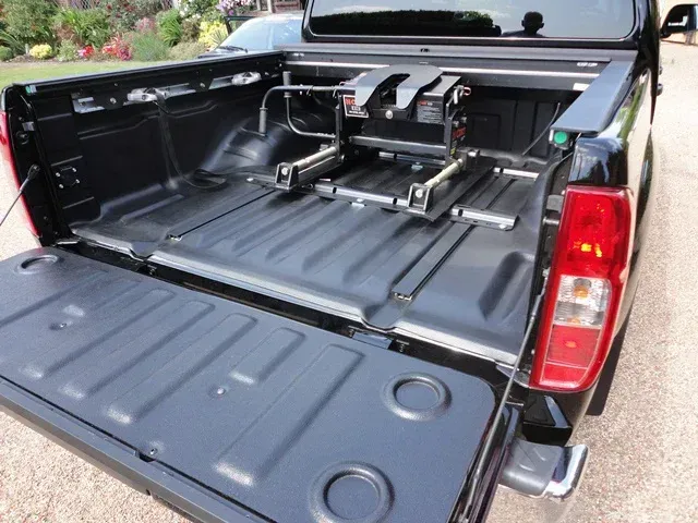 The back of a black truck with the tailgate open