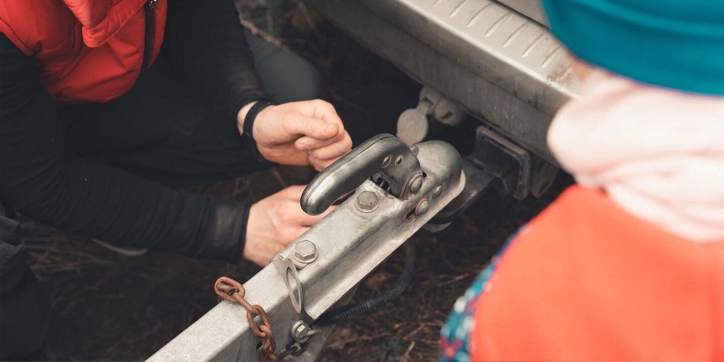 A man and a child are attaching a trailer Littleton Colorado Preventing Trailer Hitch Corrosion