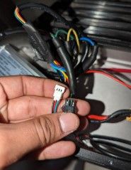 A person is holding a wire in their hand.