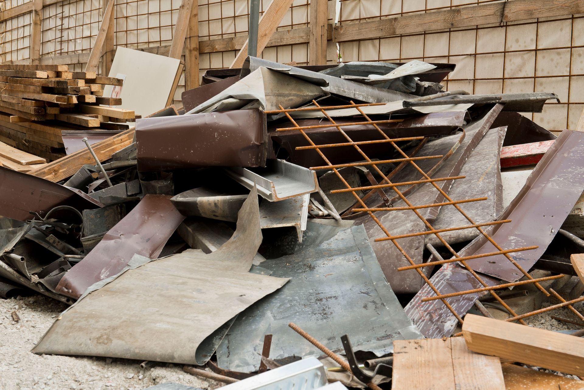 Log-laden truck trailer on a gravel surface, parked near a forest under a cloudy sky. Log-laden truck trailer on a gravel surface, parked near a forest under a cloudy sky.