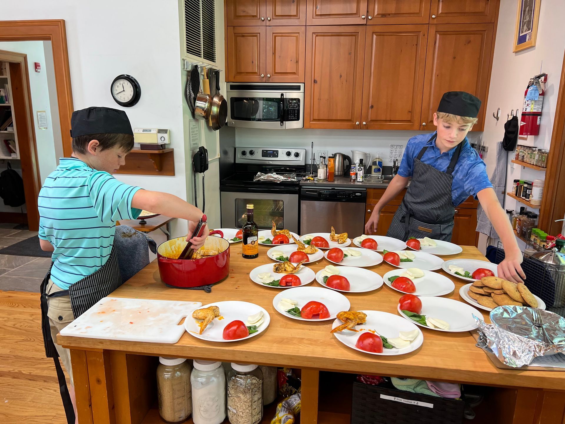 Montessori children are preparing food in a kitchen.