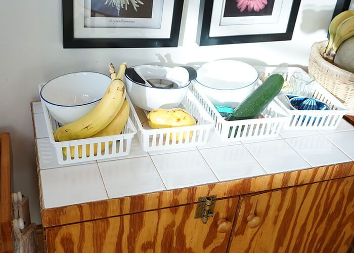 A table with a bunch of bowls and baskets on it