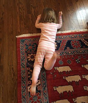 A little girl is having a tantrum on the floor.