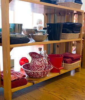 A wooden shelf with bowls and buckets on it