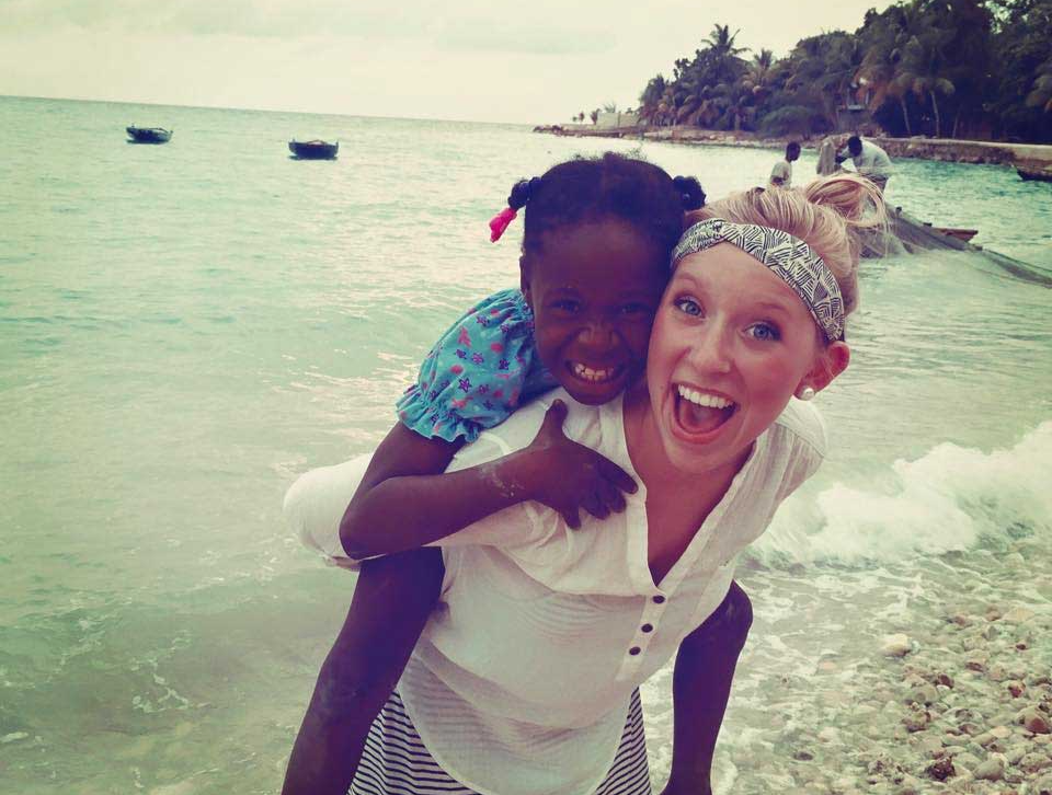 Photo of Emma with Haitian girl on beach