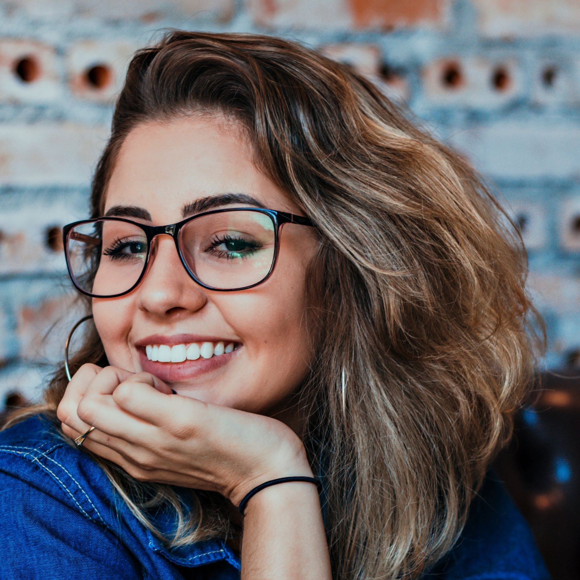 girl smiling, with glasses on