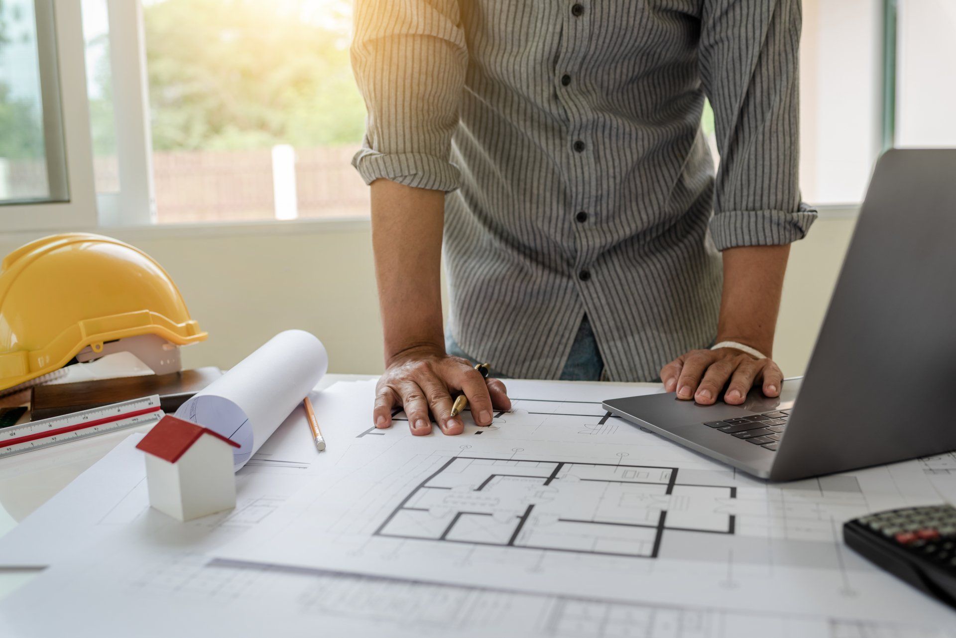 Blueprints of designer and engineers working at architects office desk.