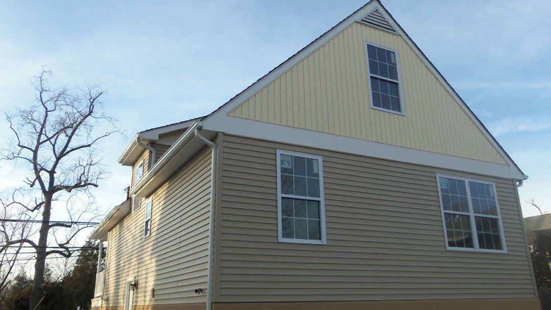 A house with a triangle shaped roof and a lot of windows