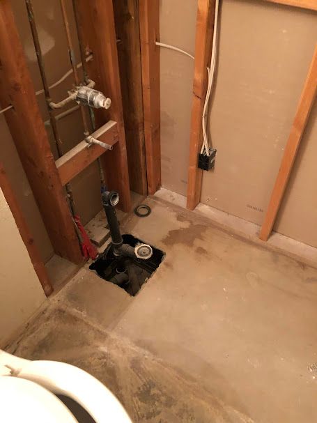 A bathroom with a toilet and a sink in it