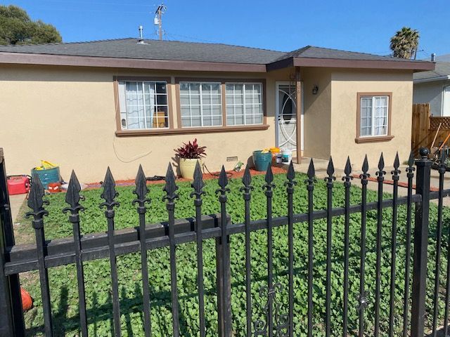 A house with a black fence in front of it