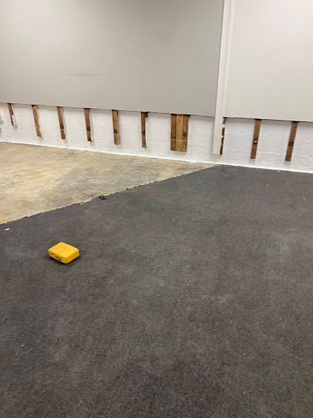 A yellow box is sitting on the floor in a room.