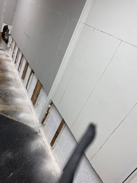 A white wall with a black shadow on it