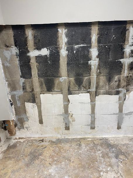 A room with a brick wall and a concrete floor.