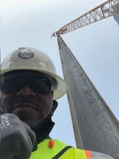 A group of construction workers are working on a brick building