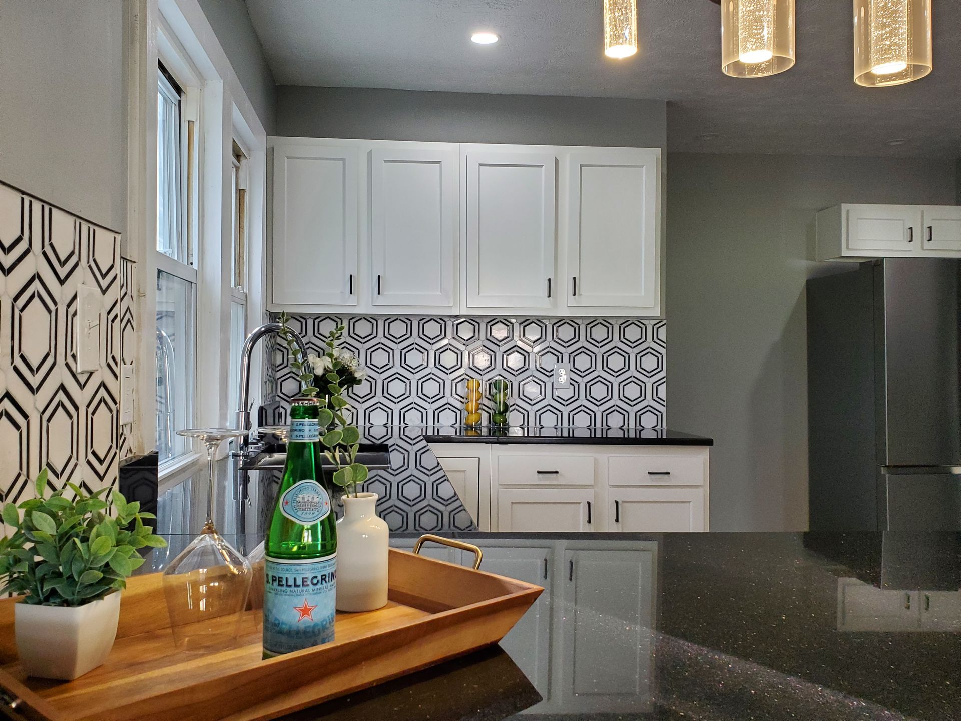 A dining room with a table and chairs and a wooden staircase.