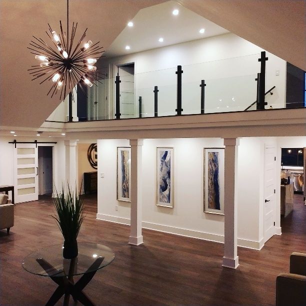 A dining room with a round table and chairs.
