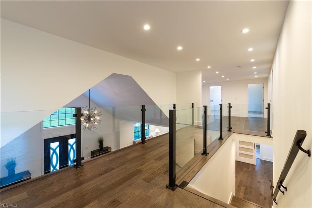 A vase of flowers is sitting on a table next to a window.