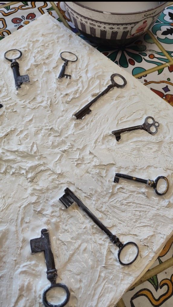 Un mazzo di chiavi è appoggiato su una superficie bianca