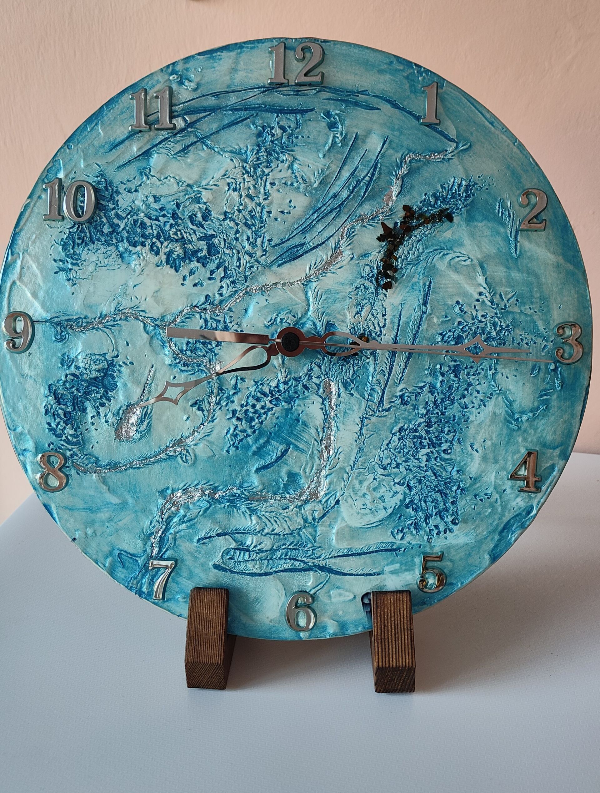 Un orologio blu e bianco su un supporto di legno