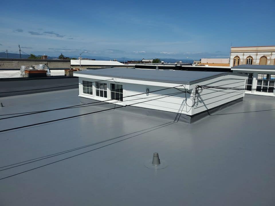 Gray Flat Roof of Commercial Building — Astoria, OR — Northwest Roofing & Construction LLC