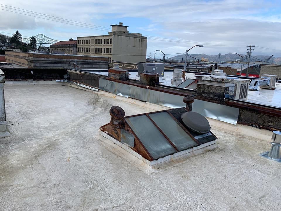 Before Renovation of Commercial Building Flat Roof — Astoria, OR — Northwest Roofing & Construction LLC