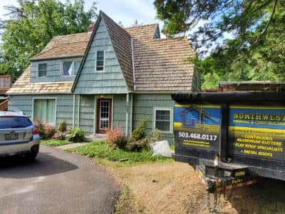 House with Signage on the Side — Astoria, OR — Northwest Roofing & Construction LLC