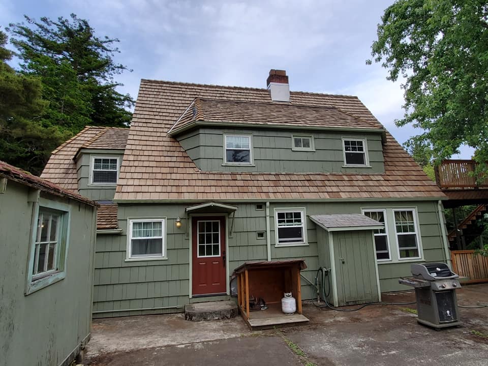 Farther View of Residential House with Green Color — Astoria, OR — Northwest Roofing & Construction LLC