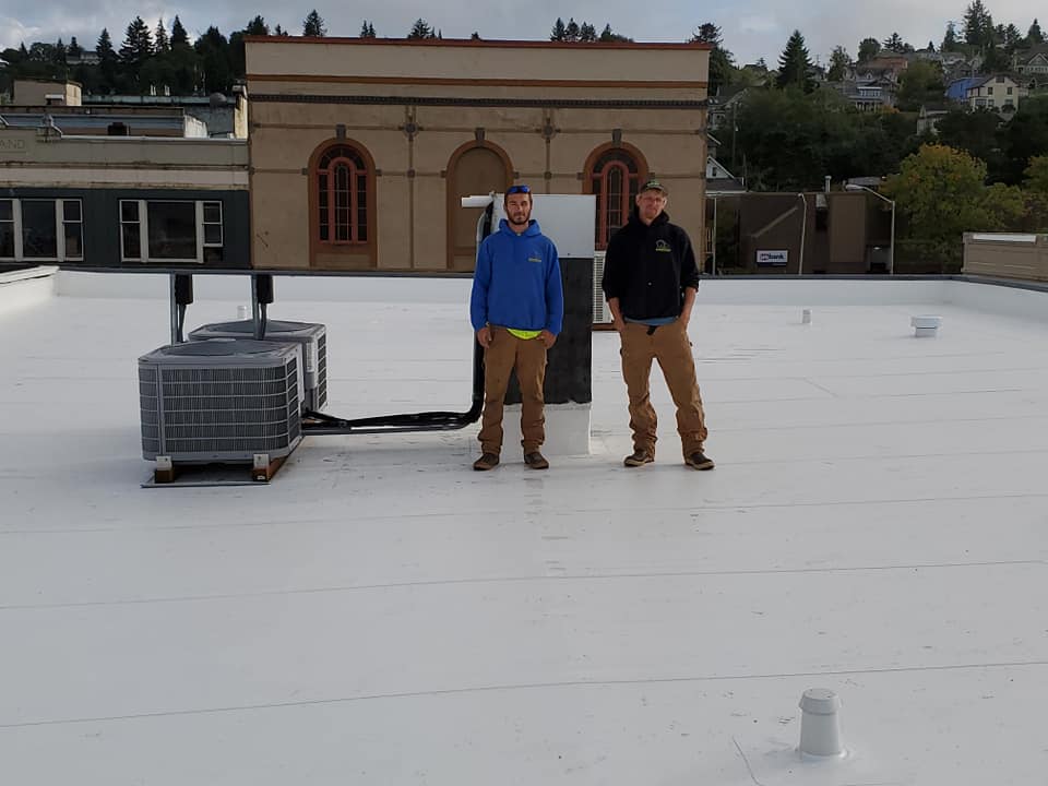 Workers at the Rooftop — Astoria, OR — Northwest Roofing & Construction LLC
