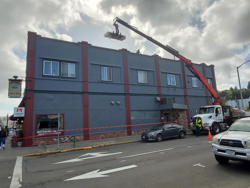 Truck Carrying Roofing Material to the Rooftop — Astoria, OR — Northwest Roofing & Construction LLC